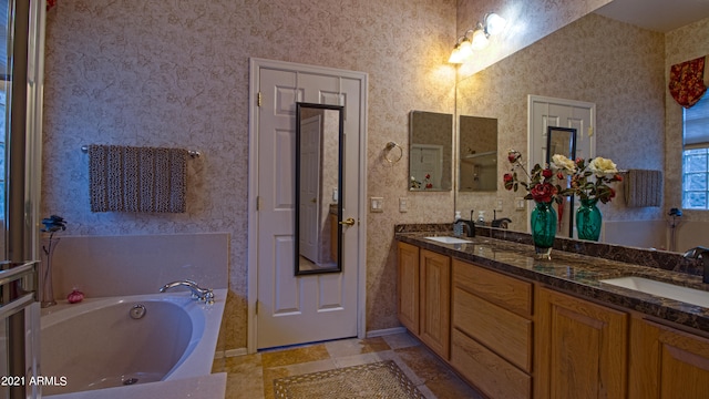 bathroom with vanity and a bath