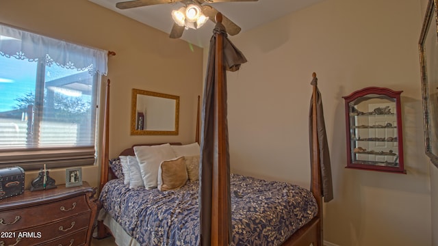 bedroom featuring multiple windows and ceiling fan