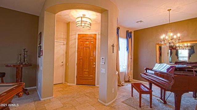 foyer entrance with a notable chandelier