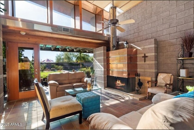 25232 N Horseshoe Trl, Scottsdale, AZ 85255 - tiled living area with a high ceiling, ceiling fan, and a lit fireplace