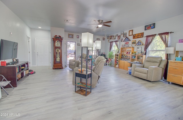 living room with ceiling fan and light hardwood / wood-style flooring