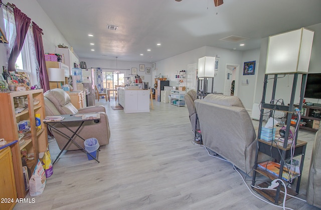 living room featuring ceiling fan and light hardwood / wood-style floors