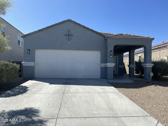 ranch-style home with a tiled roof, stucco siding, concrete driveway, and an attached garage