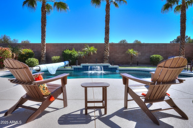 view of swimming pool with a fenced in pool, a fenced backyard, and a patio