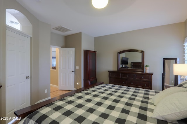 bedroom with baseboards and visible vents