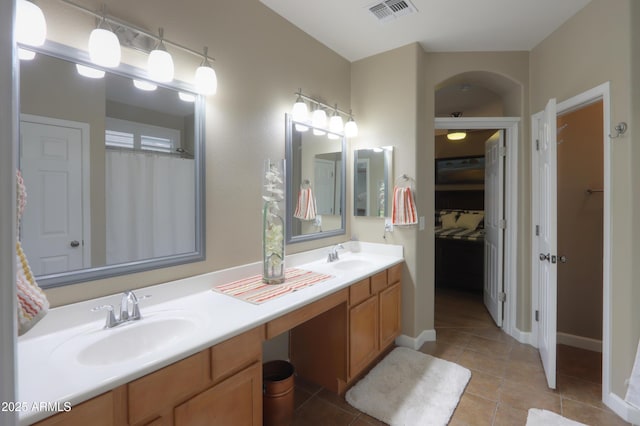 full bath with double vanity, tile patterned flooring, a sink, and visible vents