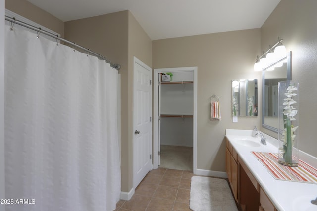 full bath with tile patterned flooring, baseboards, a closet, and vanity