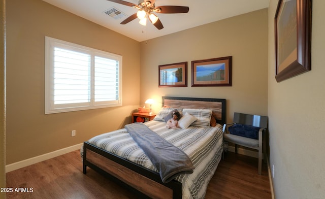 bedroom featuring dark wood-style floors, baseboards, and visible vents