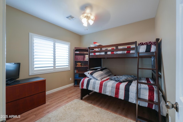 bedroom featuring light wood-type flooring, visible vents, and baseboards