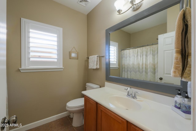 bathroom with visible vents, toilet, vanity, baseboards, and tile patterned floors