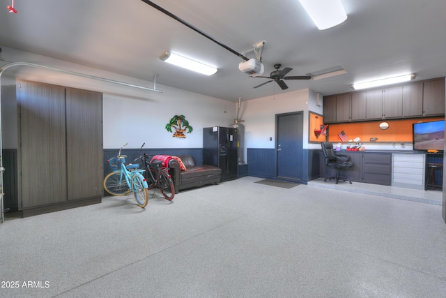 garage featuring a garage door opener and water heater