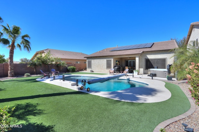 view of pool featuring a fenced in pool, a patio, a lawn, a fenced backyard, and a jacuzzi