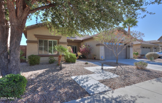 single story home with a garage, concrete driveway, and stucco siding