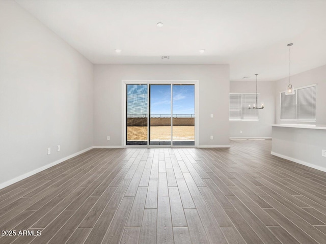 17561 W Pierson St, Goodyear, AZ 85395 - unfurnished living room with a chandelier, dark wood-type flooring, baseboards, and recessed lighting