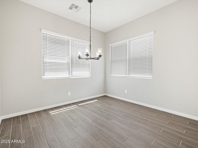 17561 W Pierson St, Goodyear, AZ 85395 - spare room with a chandelier, wood finished floors, and baseboards