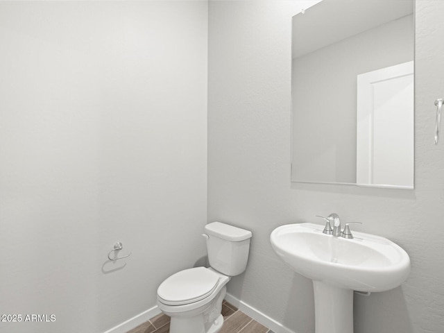 17561 W Pierson St, Goodyear, AZ 85395 - bathroom with toilet, wood finished floors, baseboards, and a sink