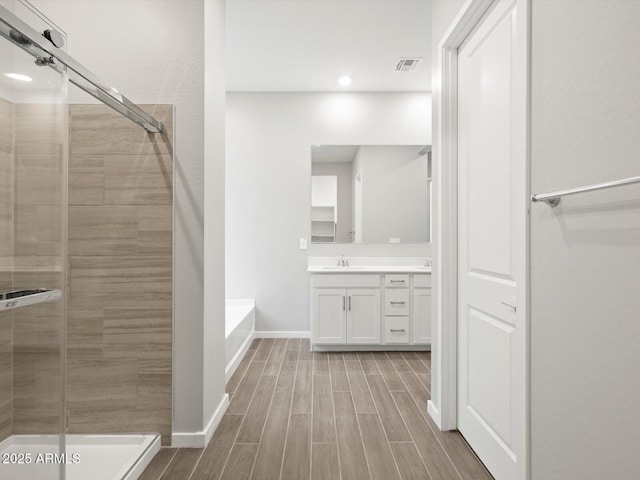17561 W Pierson St, Goodyear, AZ 85395 - full bath with vanity, a shower stall, wood finished floors, baseboards, and recessed lighting