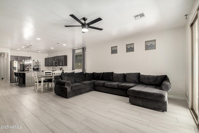 3715 S 57th Ln, Phoenix, AZ 85043 - living area with ceiling fan, recessed lighting, wood finish floors, and plenty of natural light