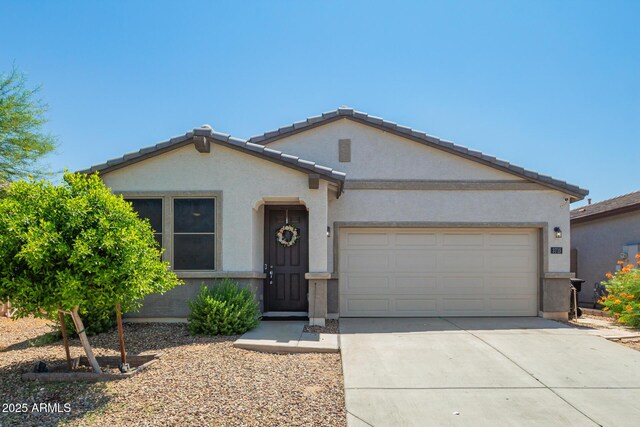 3715 S 57th Ln, Phoenix, AZ 85043 - view of front facade with an attached garage, concrete driveway, and stucco siding