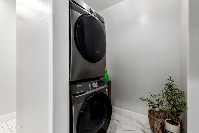 3715 S 57th Ln, Phoenix, AZ 85043 - laundry area with stacked washing machine and dryer and baseboards