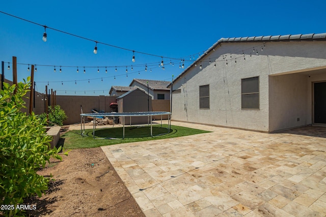 3715 S 57th Ln, Phoenix, AZ 85043 - view of yard featuring a trampoline, a patio area, and an outbuilding