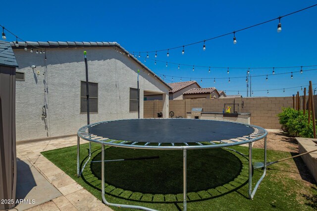 3715 S 57th Ln, Phoenix, AZ 85043 - fenced backyard featuring a trampoline