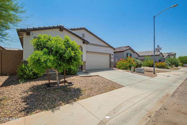 3715 S 57th Ln, Phoenix, AZ 85043 - view of front of house featuring concrete driveway, stucco siding, an attached garage, and a tile roof