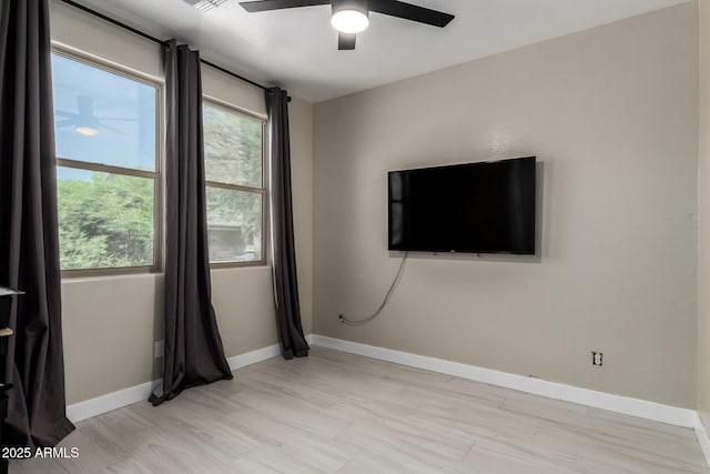 3715 S 57th Ln, Phoenix, AZ 85043 - unfurnished room featuring ceiling fan, plenty of natural light, and light wood-style floors