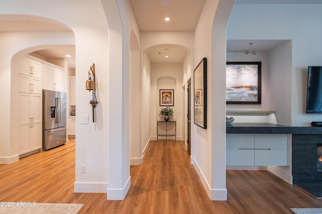 hallway with light hardwood / wood-style floors