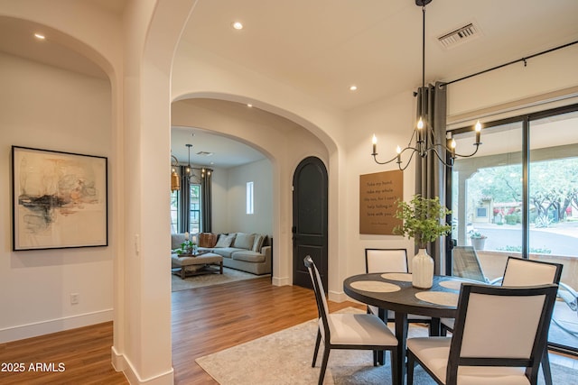 dining area featuring dark hardwood / wood-style floors and a notable chandelier