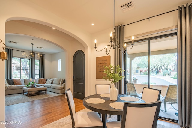 dining room featuring hardwood / wood-style floors and a chandelier