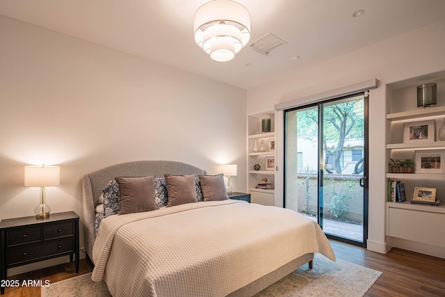 bedroom with dark wood-type flooring and access to exterior