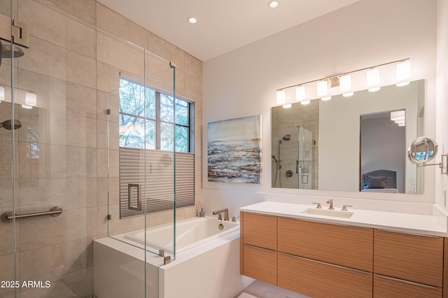 bathroom with separate shower and tub and vanity