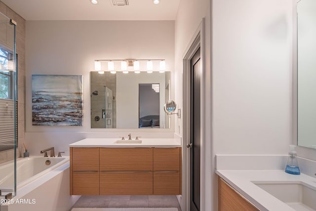 bathroom featuring vanity and shower with separate bathtub