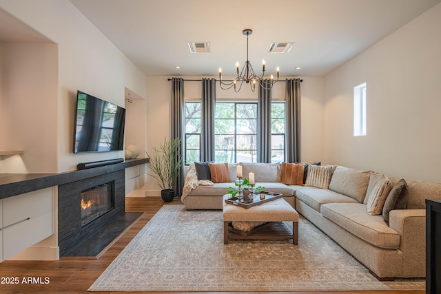 living room featuring hardwood / wood-style floors and a notable chandelier