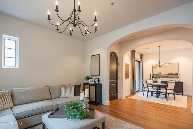 living room featuring a chandelier and wood-type flooring