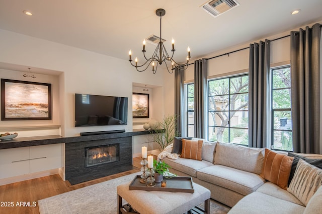 living room featuring an inviting chandelier and light hardwood / wood-style floors