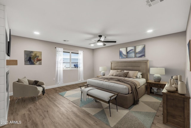 bedroom featuring light hardwood / wood-style flooring and ceiling fan