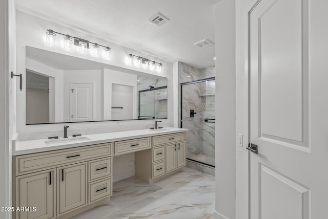 bathroom featuring vanity, a shower with shower door, and a textured ceiling