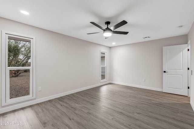 spare room featuring hardwood / wood-style flooring and ceiling fan