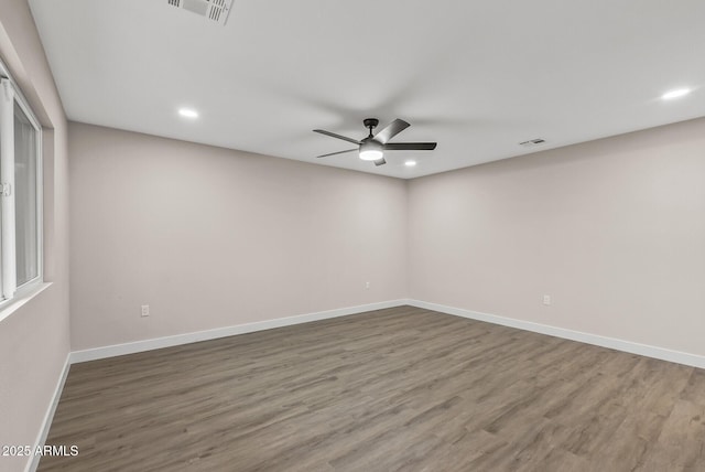 empty room with ceiling fan and hardwood / wood-style floors