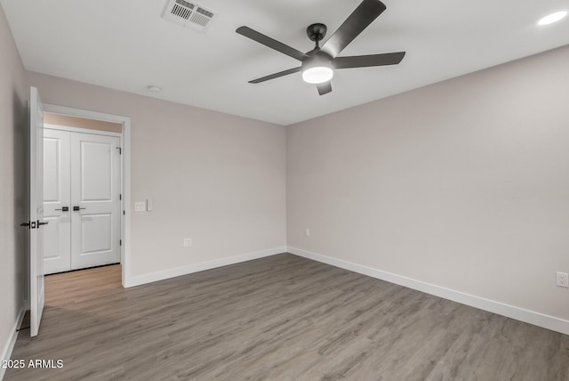 empty room featuring ceiling fan and wood-type flooring