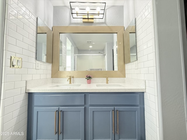 bathroom featuring a shower stall, tile walls, and a sink