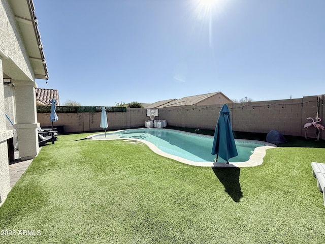 view of pool featuring a fenced in pool, a fenced backyard, and a lawn