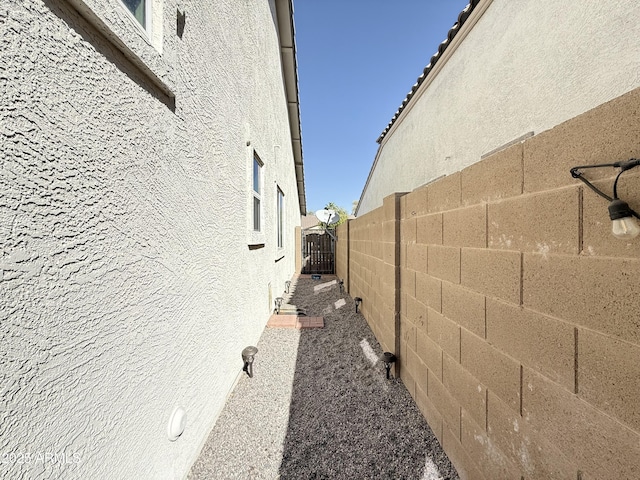 view of property exterior with fence and stucco siding