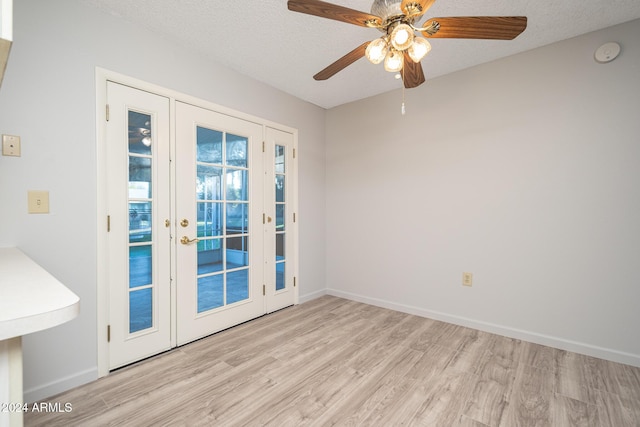 interior space with french doors, a textured ceiling, light hardwood / wood-style floors, and ceiling fan