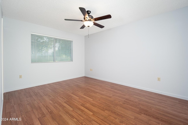 spare room with wood-type flooring, a textured ceiling, and ceiling fan