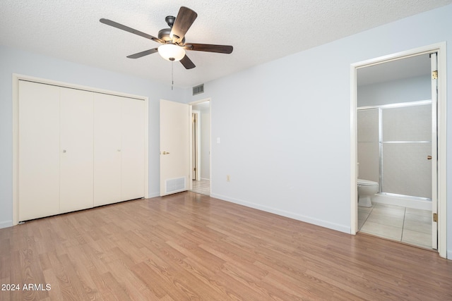 unfurnished bedroom with ceiling fan, light hardwood / wood-style floors, and a textured ceiling