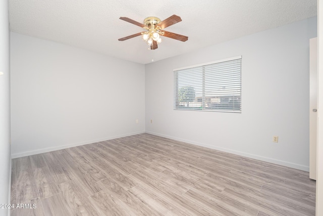 unfurnished room featuring ceiling fan, a textured ceiling, and light hardwood / wood-style flooring