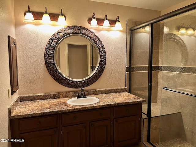 bathroom featuring vanity and a shower with door